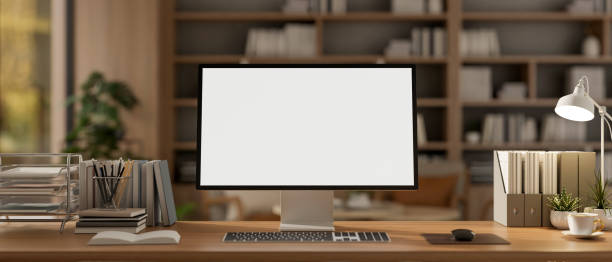 istock A computer and decorative items placed on a wooden desk in a contemporary cozy office. 2197694496
