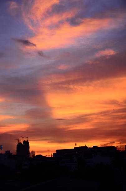 Scenic view dramatic beautiful sunset sky. Natural Sunset Sunrise on meadow silhouette shadow dark land. Vibrant dramatic sky on sunset, dawn, sunrise in Countryside. Landscape Colorful Sky At Sunset