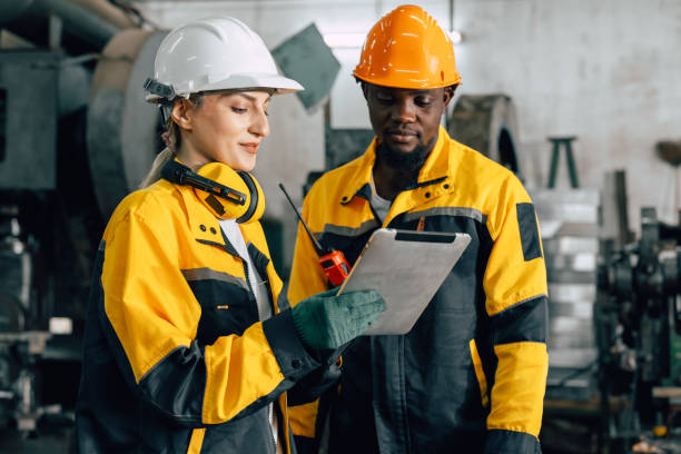 istock professional engineer team inspecting service machine in heavy industry factory 2197703299