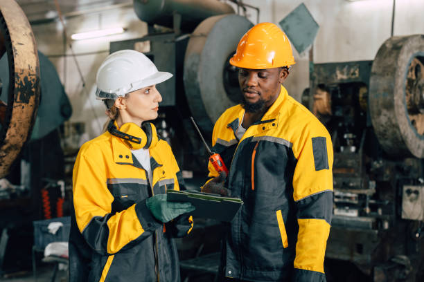 istock professional engineer team inspecting service machine in heavy industry factory 2197703304