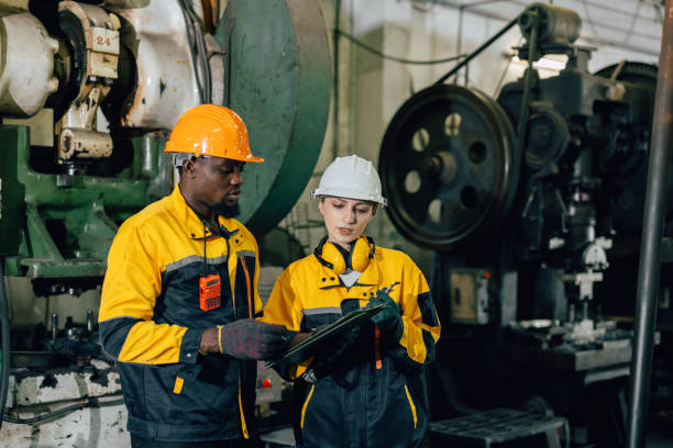 istock professional engineer team inspecting service machine in heavy industry factory 2197703316