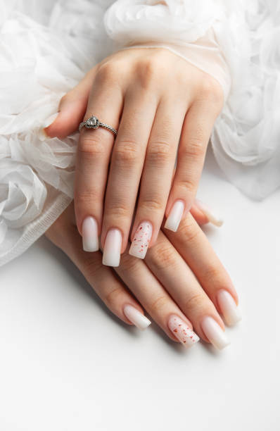 istock Bride showing her beautiful white nails and engagement ring 2197709495