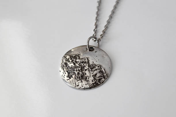 istock Stunning handmade silver pendant with unique textured surface that catches light beautifully. 2197710612