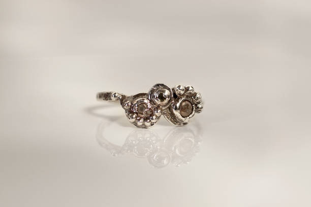 istock Handmade silver ring with unique organic design and raw gemstone on a white background. 2197710620