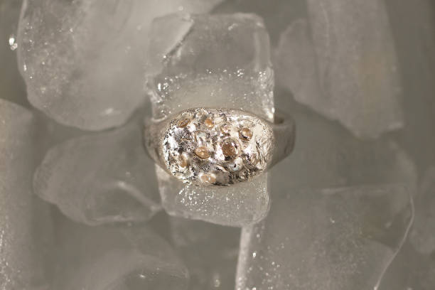 istock Top view on unique handmade silver ring inspired by natural textures with gemstones on ice cubes. 2197710724