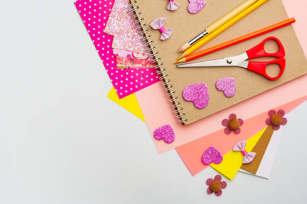 istock Craft supplies arranged with colorful paper, scissors, and decorations for DIY projects at a workspace 2197710901