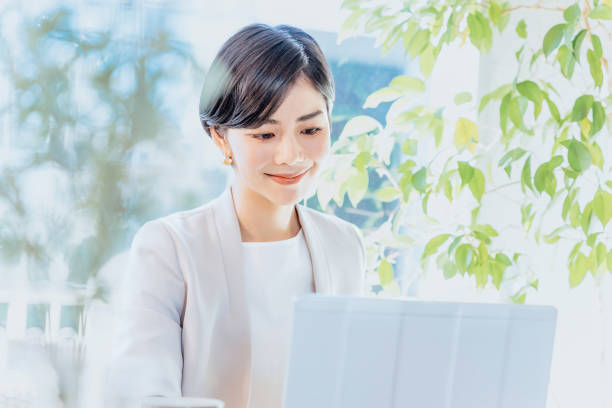 istock A smiling woman in her 30s working on a computer in a bright room 2197713402