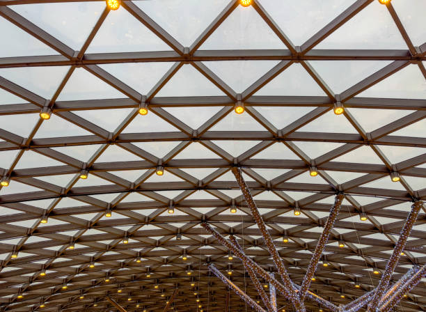 A large, open space with a lot of light shining down on it. The space is filled with many lights, creating a bright and airy atmosphere. Scene is one of openness and brightness