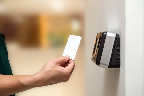 istock Office man using the ID card to scan at the access control system machine for check attendance and open the security door 2197716881
