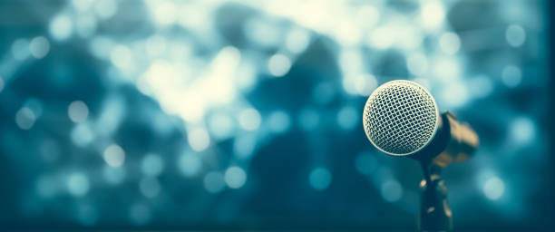 istock Public speaking backgrounds, Close-up the microphone on stand for speaker speech at seminar room with technology light background and blur bokeh. 2197716969