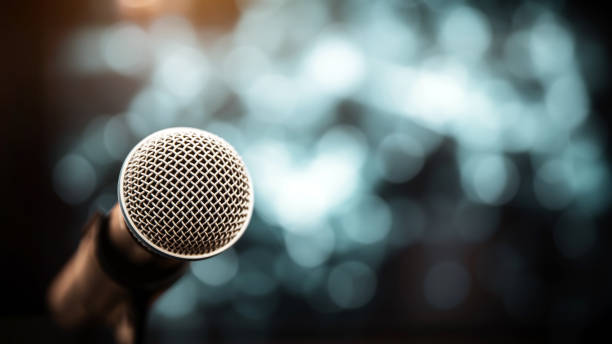 istock Public speaking backgrounds, Close-up the microphone on stand for speaker speech at seminar room with technology light background and blur bokeh. 2197717237