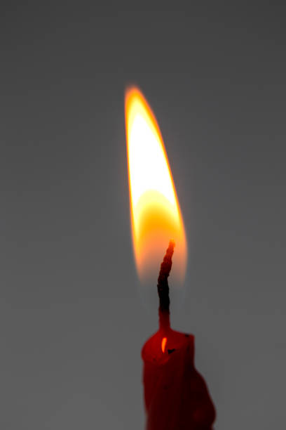 red candle and flame. macro, close up.