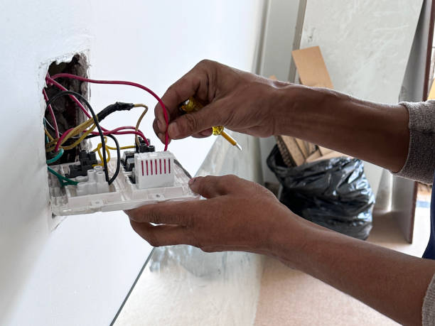Image of electrician fixing electrical socket and plug / handling wires, electrics, demonstrating danger, wiring, safety-conscious environment stock photo