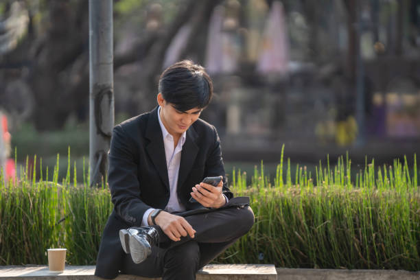 istock Businessman using iPad and mobile phone to talk business while waiting to enter office. 2197721824