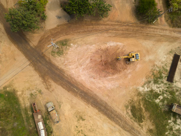 istock A yellow excavator is moving a pile of soil. 2197722049