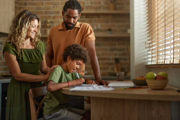 istock Diverse parents assisting their small son with studying at home. 2197722881