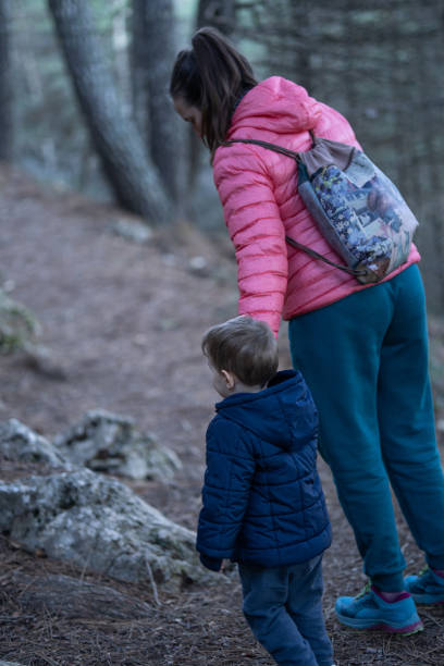 istock mother walks with her son along a trail 2197724190