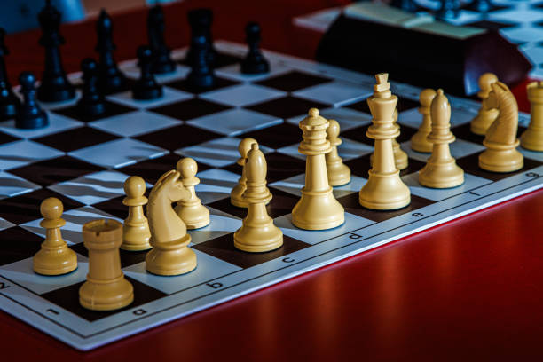 istock Closeup of a chessboard with pieces ready for play. Professional chess set arranged for a match, highlighting logic, tactics, and strategic thinking in a competitive and intellectual board game 2197725528