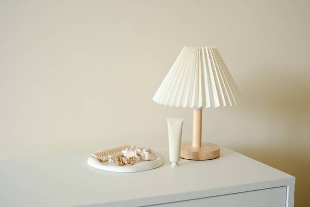 istock An elegant modern table Lamp featuring Neutral Decor Accents , woman accesseries on white concrete plate on white desser in light room. 2197725800
