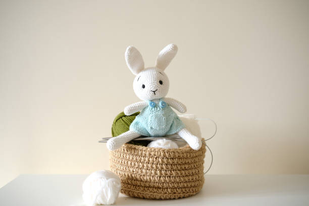 istock This adorable and delightful knitted rabbit toy comes beautifully packaged with yarn and a basket. 2197726323