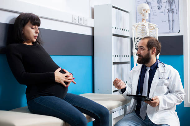 istock Doctor uses tablet at pregnancy checkup 2197727245