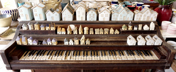 Group of little house model ceramic on old piano