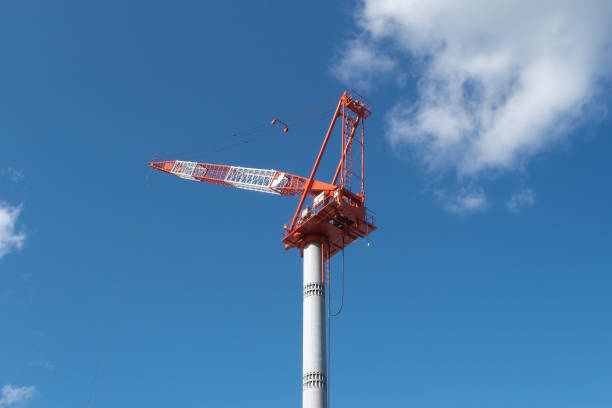 A crane at a construction site and cloudy sky background in Japan