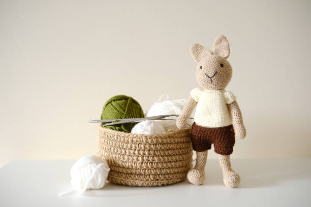 istock This adorable and delightful knitted rabbit toy comes beautifully packaged with yarn and a basket. 2197728817