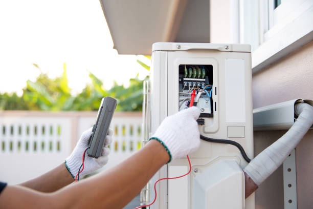 istock Close up hand of technician using measuring equipment to checking electric current voltage at circuit breaker on outdoor air compressor unit after installation and air conditioner services maintenance 2197729426