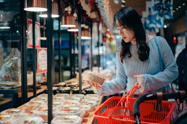 istock An Asian woman is using her smartphone while enjoying a meal at a restaurant. She completes her online food order through the tech device and settles the payment with a digital wallet. This is a blend of people, food, lifestyle, and technology. 2197731802