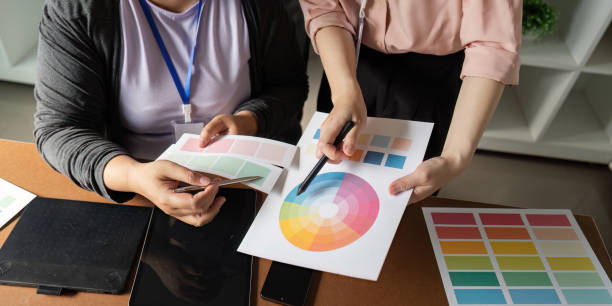istock Graphic design team reviewing color palettes and materials in a creative workspace. 2197731854
