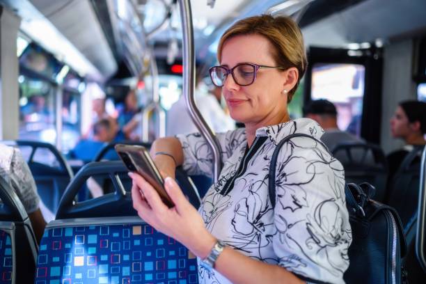 istock Woman using phone in public transportation while traveling 2197732178
