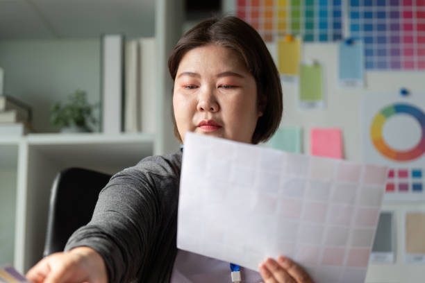 istock Diverse graphic designer selecting color swatches for a project in a workspace. 2197733226