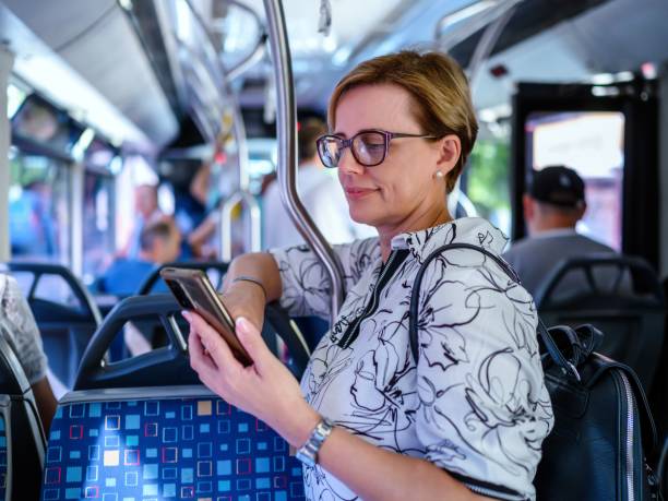 istock Woman using phone in public transportation while traveling 2197733282