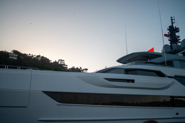 Istanbul, Turkey - July 1, 2023: Tourists are riding the boat, take photos and enjoy the sunset.