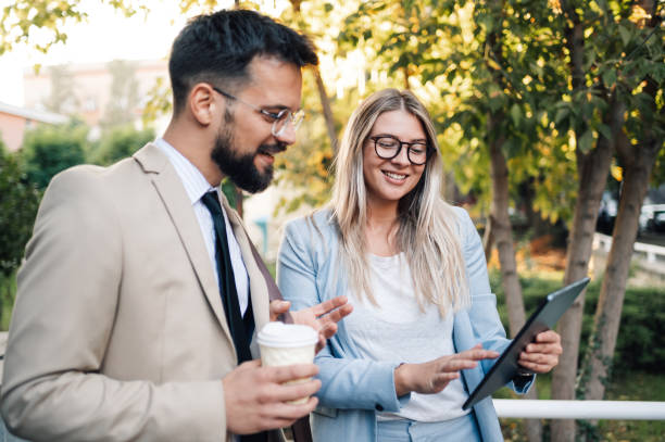 istock Business people having informal meeting using tablet and drinking coffee 2197738573