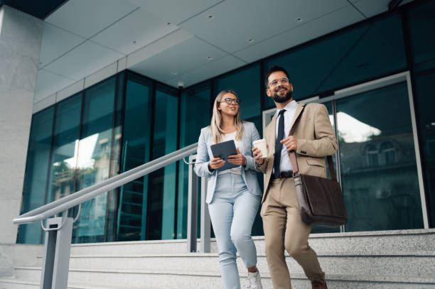 istock Business people walking and talking outside office building 2197738672