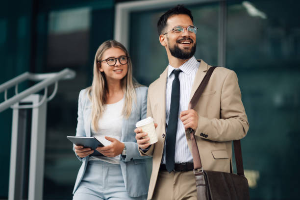 istock Business people walking and talking outside office building 2197738701