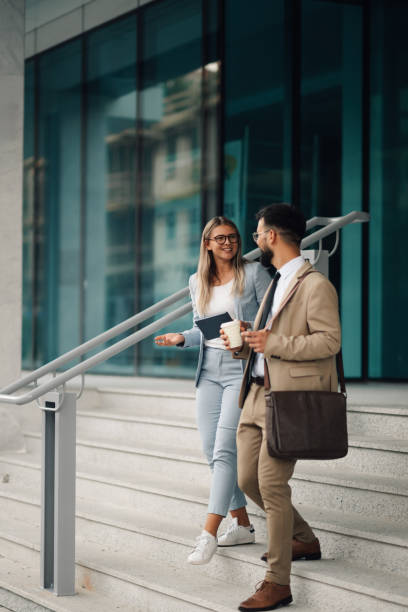 istock Business people walking down stairs and talking about business strategy 2197738718