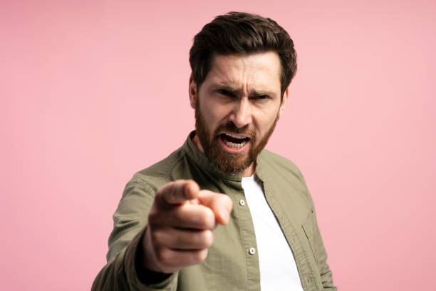 istock Bearded man standing over pink background pointing displeased and angry to camera 2197740338