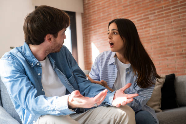 istock Serious relationship problems between young couple sitting apart on a sofa at home, dealing with betrayal, emotional pain, financial struggles, and discussing the uncertain future of their relationship and possible separation 2197743851