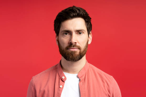 istock Calm man wearing casual shirt posing at camera isolated on red background 2197743926