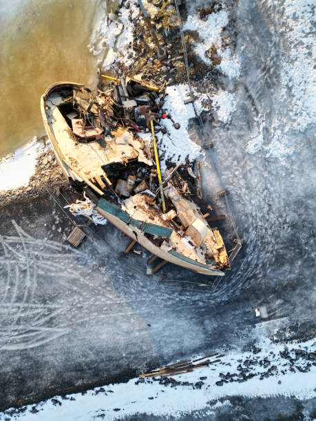 istock Wrecked old fishing ship on icy ground 2197744560