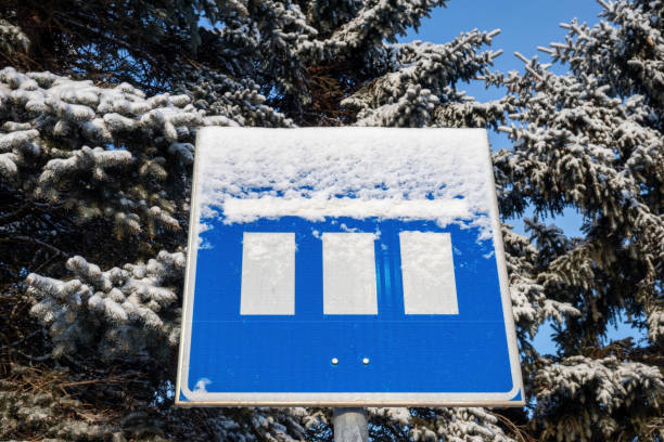 parking lot sign covered in snow in winter
