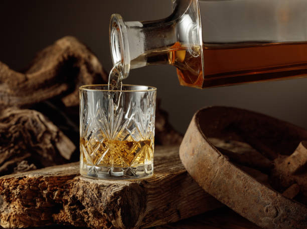 istock Whiskey is poured from a decanter into a glass. 2197745551