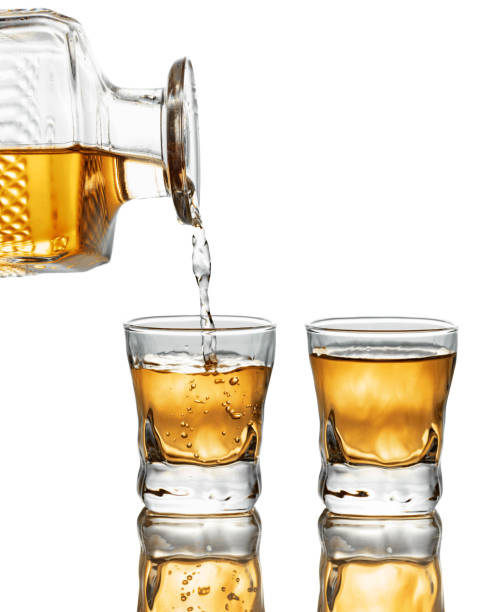 istock Gold liquor pouring into a glass on a white background. 2197745598