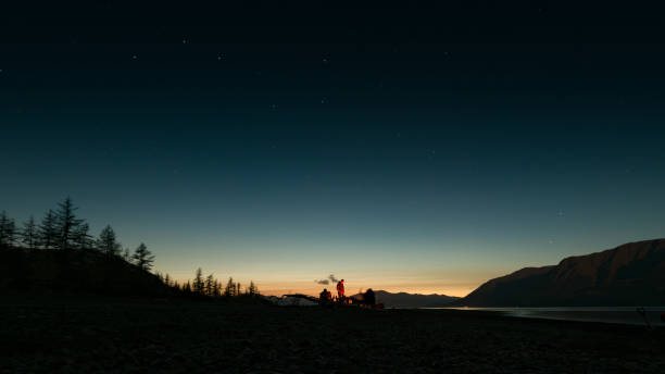 istock Campfire by the Lake Under a Starry Sky 2197748046