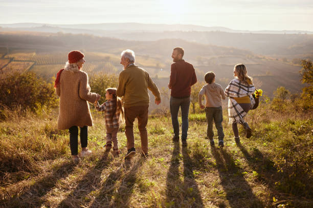 istock Back view of happy multi-generation family running down the hill. 2197749968