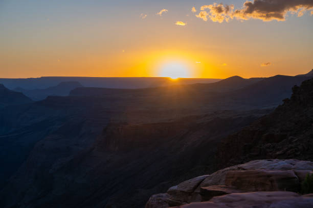 Sunset at Toroweap Lookout on the North Rim of the Grand Canyon. This stunning overlook showcases dramatic cliffs, deep canyons, the Colorado River and golden light painting the rugged landscape, creating a mesmerizing natural wonder. Toroweap is a very remote location and very challenging to get to.