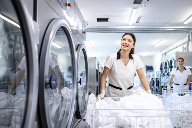 istock Professional cleaner working in dry cleaning service. 2197751075